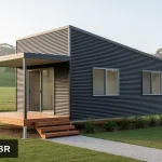 Artist's impression of the Boolarra 1 bedroom skillion roof kit home in horizontal corrugated Colorbond Monument, raised on a steel subfloor with a covered front verandah and steps, in Gippsland