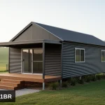 Artist's impression of the Koonwarra 1 bedroom gable roof kit home in horizontal corrugated Colorbond Monument, raised on a steel subfloor with a covered front verandah and steps, in Gippsland
